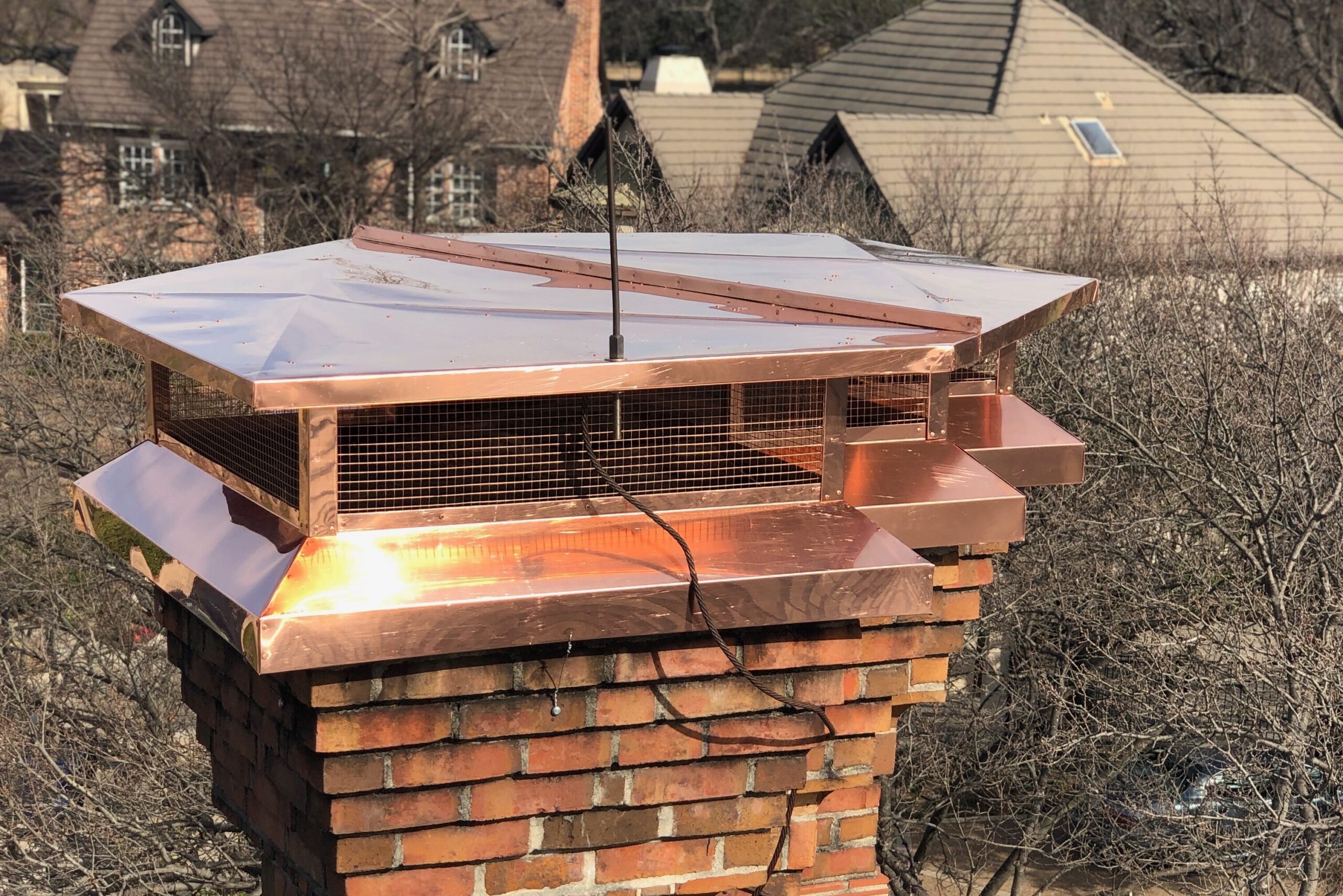 Lustrous copper chimney cap installed on a DFW home